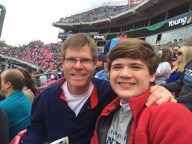 NuBody Concepts plastic surgeon Dr Rosdeutscher with his son at a Titans game