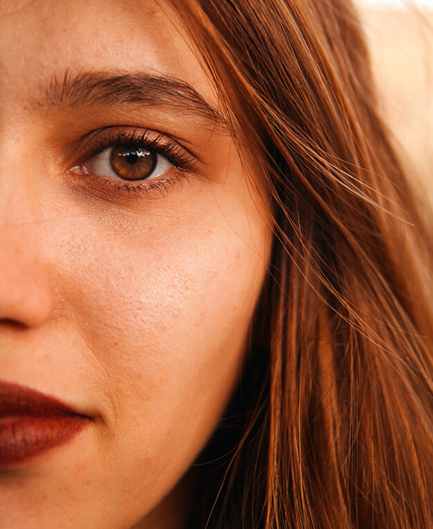 Close up of a woman's face after eyelid surgery.